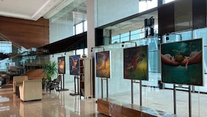 A spacious lobby with a polished marble floor, a staircase, and a series of framed artworks on display. - Spacey 2Br With Access Mall At Apartment Aryaduta Residence Surabaya (Surabaya)