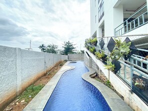 Outdoor pool - Compact Wood Accents Studio Apartment Grand Kamala Lagoon (Bekasi)