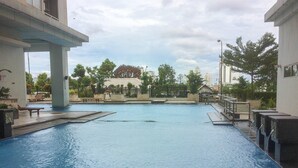 Ein Schwimmbecken mit Blick auf umliegende Gebäude und Bäume.
