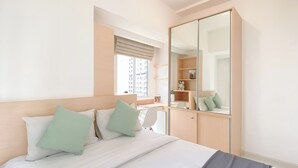 A neatly arranged bedroom with a bed, a wardrobe, and a desk. - Lovely And Pleasant 2Br Apartment At Tokyo Riverside Pik 2 (Teluknaga)