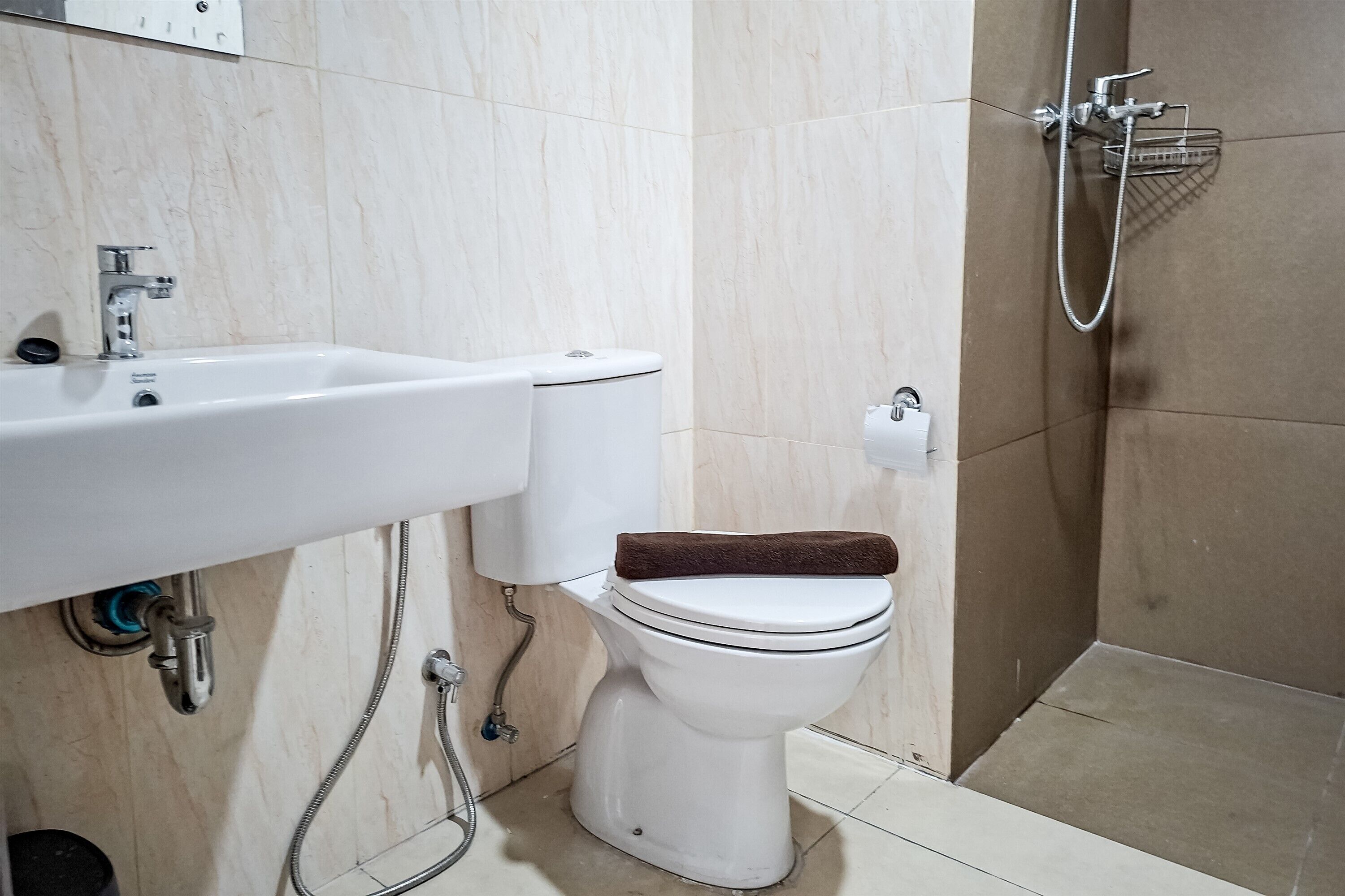 A bathroom with a white sink, toilet, and shower.