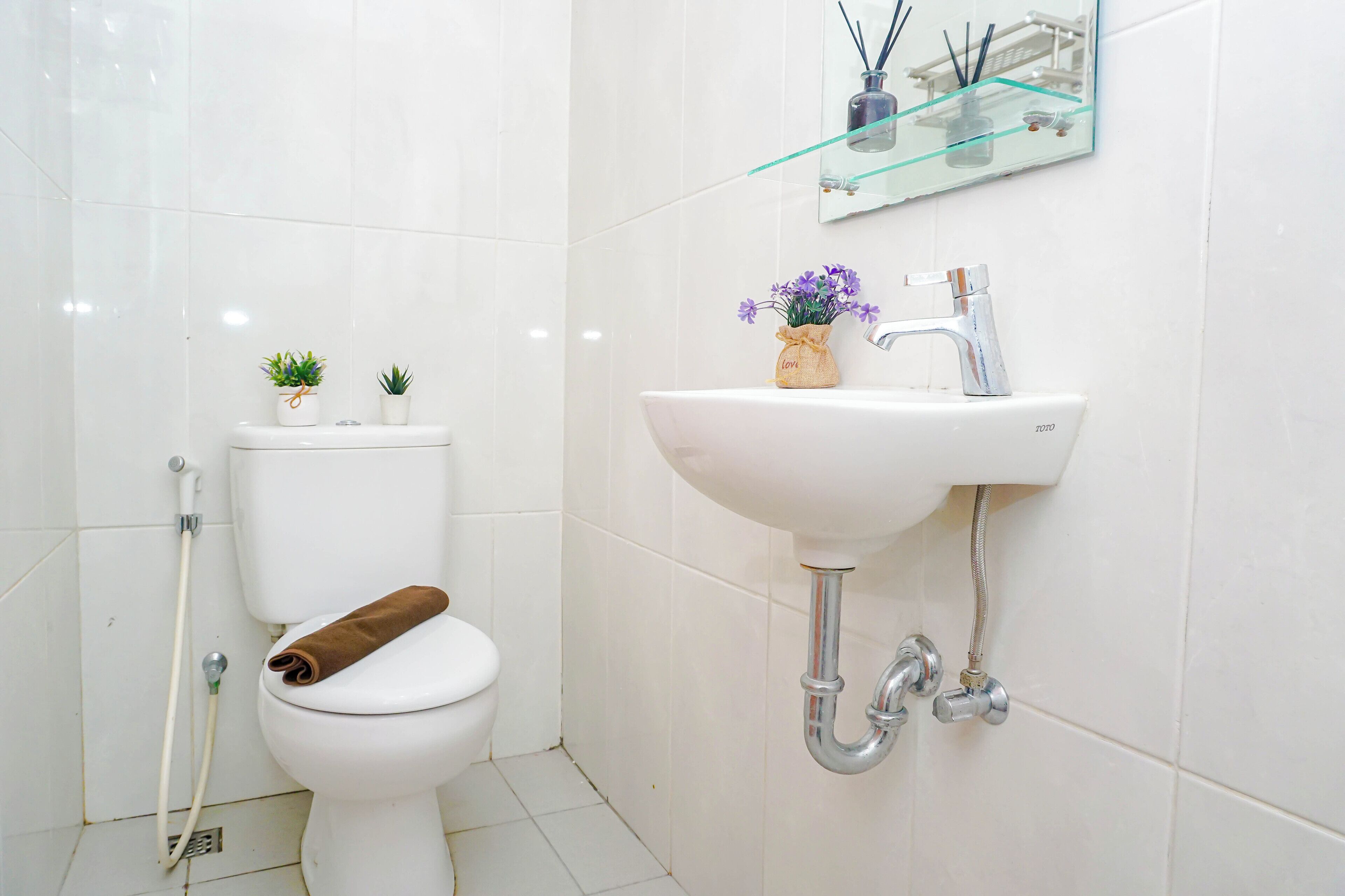 Une salle de bain avec des toilettes, un lavabo et une douche.