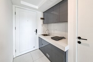 Standard Apartment | Private kitchen - Cozy White Loft Studio At Kingland Avenue Apartment (South Tangerang)