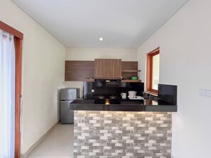 A compact kitchen with a central island, built-in appliances, and a modern design. - 3BR Jimbaran Villa at Casa De Uli Bali (Jimbaran)