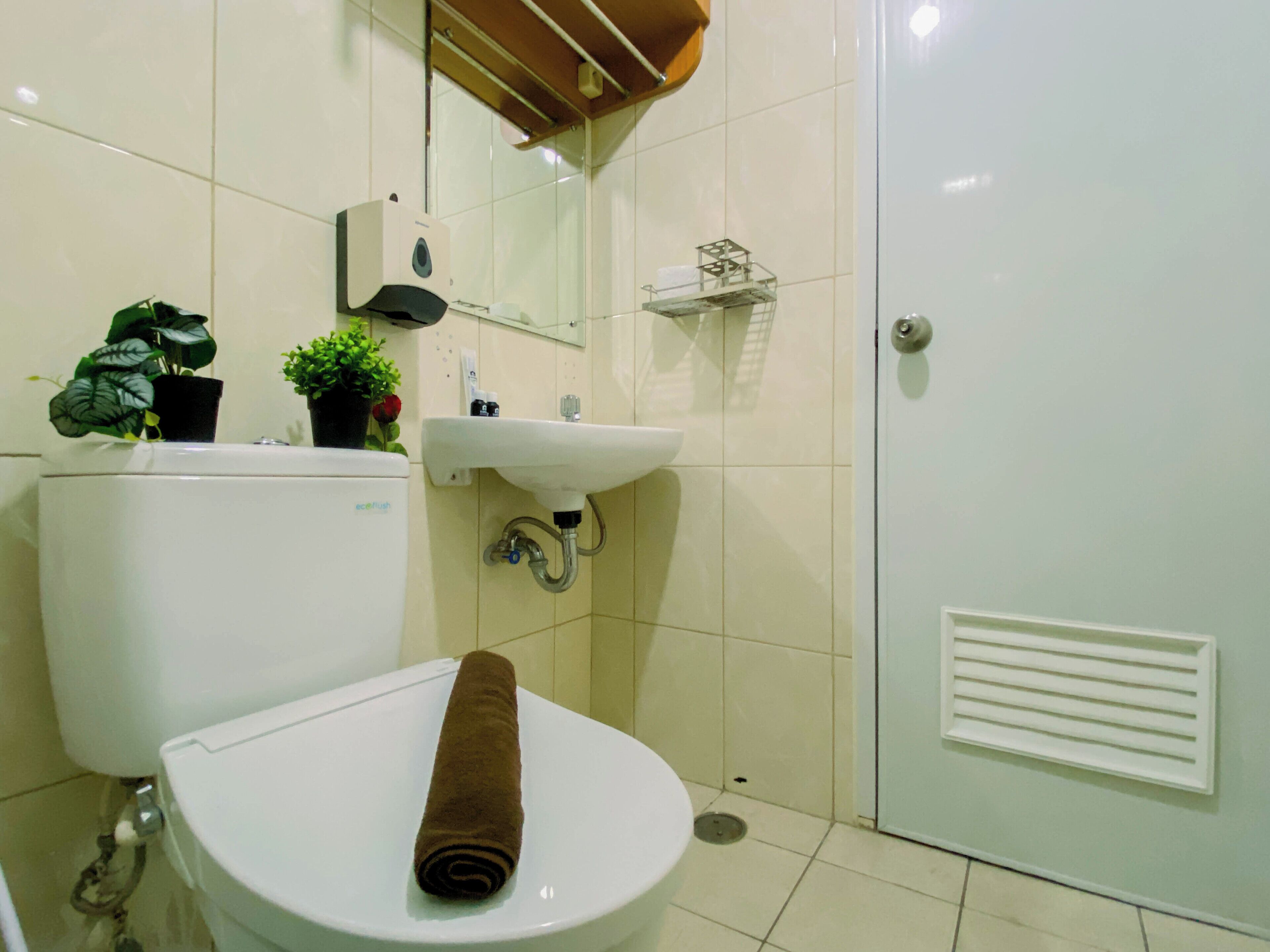 A bathroom with a toilet, sink, and shower.