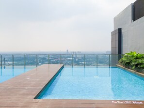 Outdoor pool - Wooden Accents 1Br Without Living Room At Bintaro Embarcadero Apartment (South Tangerang)