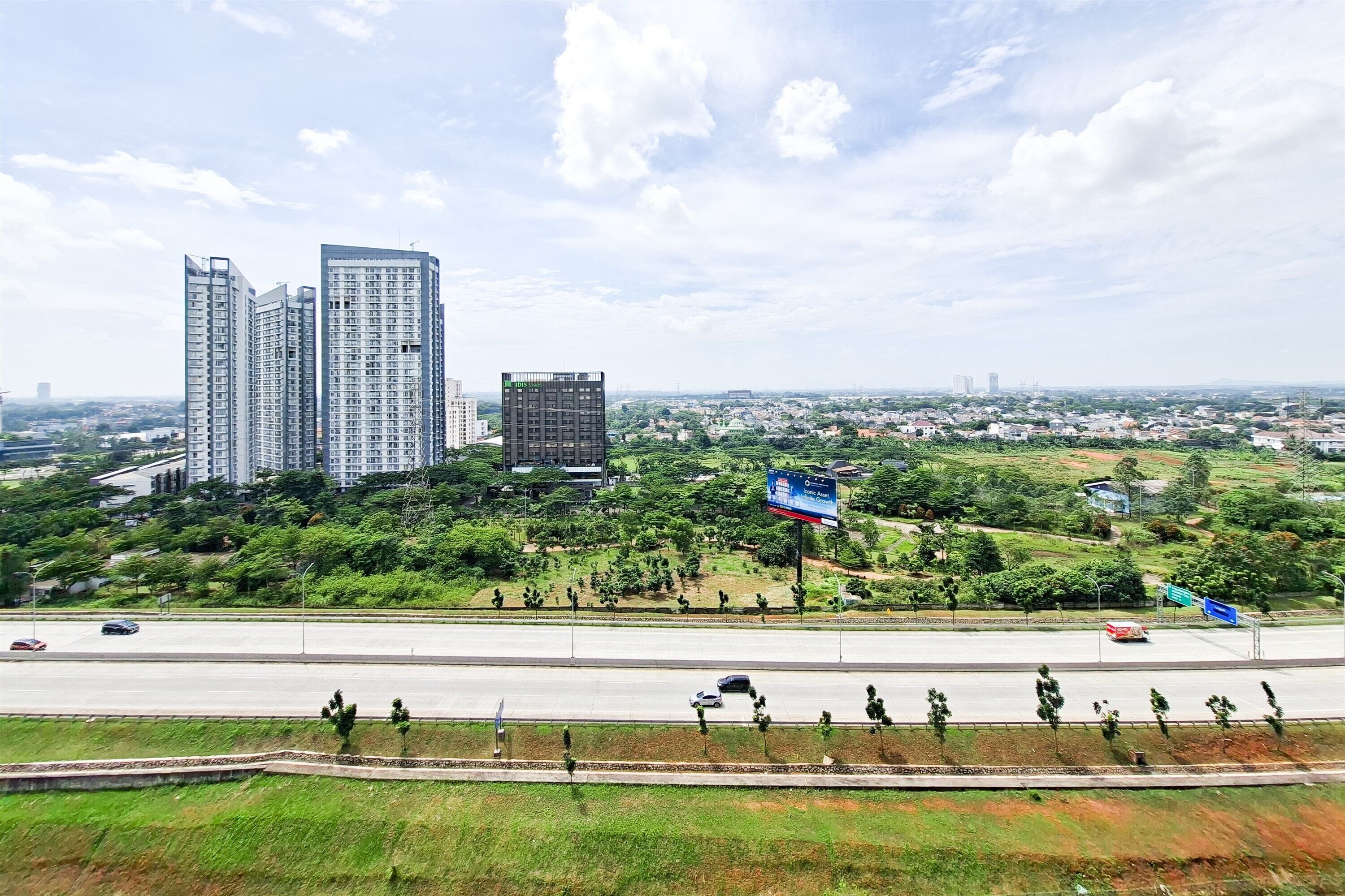 A high-rise building complex with multiple residential towers and a billboard.