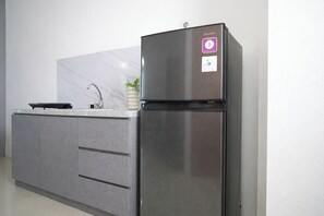 Standard Apartment | Private kitchen - 2Br Apartment With Service Room And Sofa Bed At Woodland Park Residence (Jakarta)