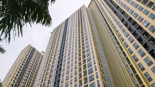 A high-rise building with multiple floors, featuring a grid-like facade with numerous windows and balconies. - Chic Studio Near Trans Studio Cibubur At Transpark Cibubur Apartment (Depok)