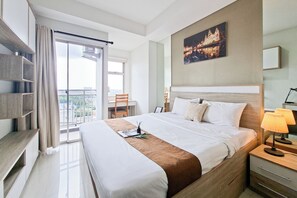 A modern hotel room with a large bed, a desk, and a balcony with a view. - Enjoy Living Studio For 2 Pax At Springwood Residence Tangerang (Tangerang)
