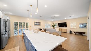 A modern kitchen with a large island, built-in appliances, and pendant lighting. - 3229 Managed by Brampton Park (Pompano Beach)