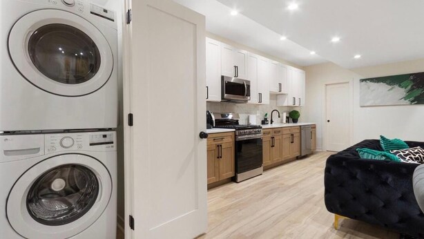 A compact kitchen with white cabinets, a microwave, and a stove.