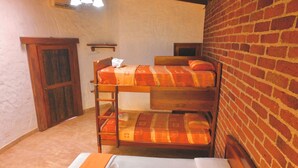 A bunk bed with orange bedding, a wooden ladder, and a white mattress at the bottom. - Puerto Quito Lodge - Mon Par (Puerto Quito)