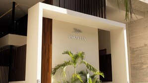 A modern building with a sign reading "PARAVIAN". - Paravian 704 2BR Condo Playa del Carmen (Playa del Carmen)