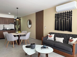 A modern living room with a grey sofa, round coffee table, and grey chairs. - Near the beach in the marina with beautiful views (Mazatlán)