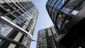 A modern high-rise building with curved glass facades and a clear sky. - Modern and Cozy 1-Bedroom Apartment in Phillip (Phillip)