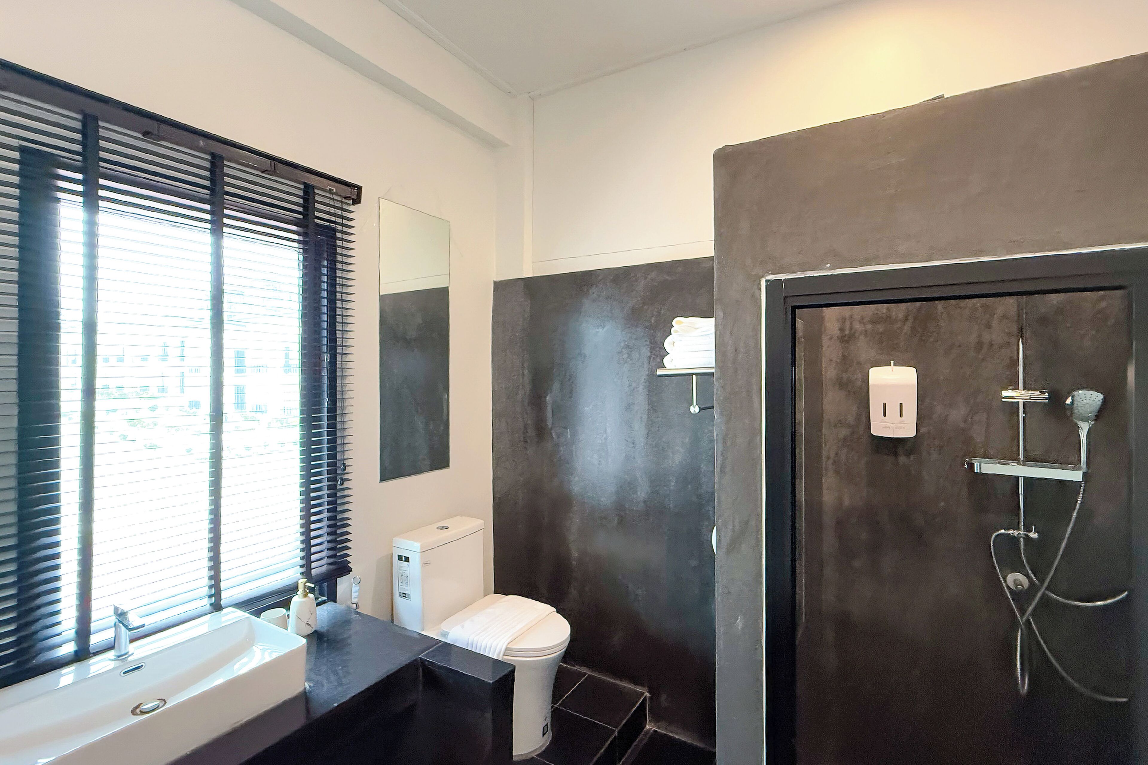 A modern bathroom with a bathtub, toilet, and sink.