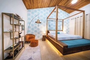 A bedroom with a canopy bed, a wooden ceiling, a bookshelf, and a patterned rug. - 5BR/6BA Luxury Jungle Villa w/ Breathtaking Views! (Playa Hermosa)