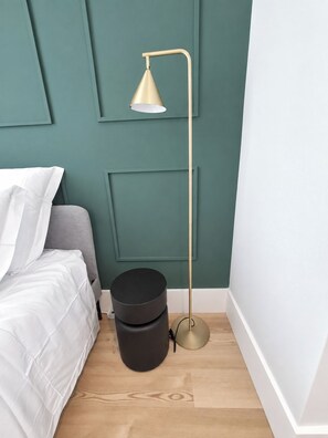 A room with a bed, a floor lamp, and a black trash bin. - Studio 402 Lisbon • Elevator • AC • Wi-Fi (Lisbon)