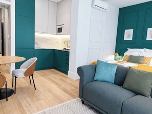 Open view across the studio featuring the fitted kitchen, dining space, lounge and bed - Studio 205 Lisbon • Balcony • Elevator • AC • WiFi (Lisbon)