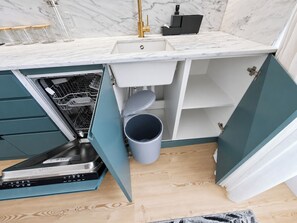 A compact kitchen with a dishwasher, a sink, and a trash bin. - Studio 302 Lisbon • Balcony • Elevator • AC • WiFi (Lisbon)