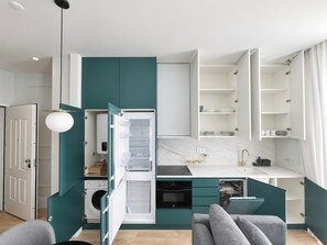 A compact kitchen with a built-in dishwasher, a sink, and a countertop. - Studio 302 Lisbon • Balcony • Elevator • AC • WiFi (Lisbon)
