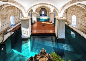 An indoor swimming pool with arched ceilings and stone walls. - Studio 305 Lisbon • Balcony • Elevator • AC • WiFi (Lisbon)