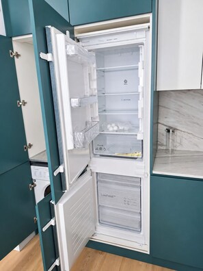 A modern kitchen with a built-in refrigerator, a microwave, and a sink. - Studio 201 • Lisbon • Balcony • Elevator • WiFi (Lisbon)