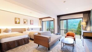 A hotel room with two beds, a sofa, a chair, a desk, and a balcony with a view of the mountains. - TAOYA Hakone (Hakone)