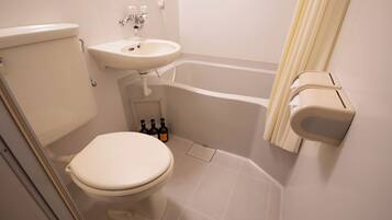 A bathroom with a toilet, sink, and bathtub.