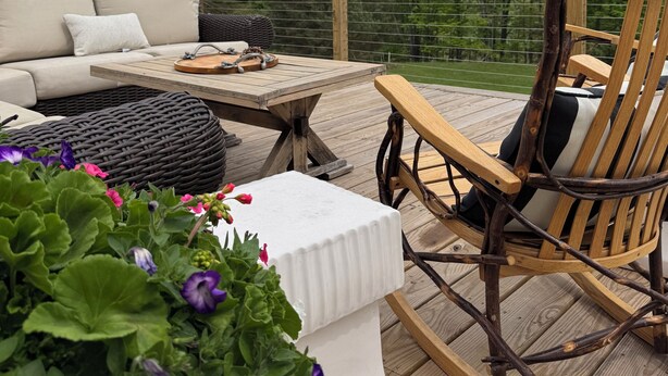 An outdoor deck with a wooden chair, a sofa, and a table. - NEW! Farmhouse Mountain View’s,FireplaceGrill, Pet-Friendly, Soaking Tub (Windham)