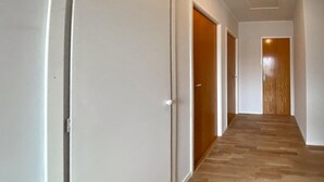 A hallway with white walls and wooden doors. - 3 bedroom beautiful home in Borgholm (Borgholm)