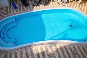 An outdoor swimming pool with a tiled deck and lounge chairs. - Villa Fortunata - Small Apartment Left, Terracina, Italy (Terracina)
