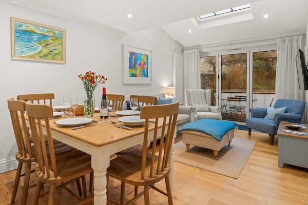 Styled in a soft palette of neutral tones, the living and dining room is a welcoming space to relax and spend time together.