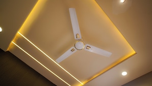 A ceiling with a central fan, recessed lighting, and a modern design. - THE SPARK INN (Jaipur)