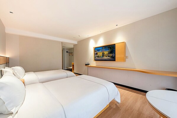 A hotel room with two beds, a TV mounted on the wall, and a wooden floor. - Mant International Hotel Ancient Whampoa Anchorage Scenic Spot Canton Fair Complex Branch (Guangzhou)