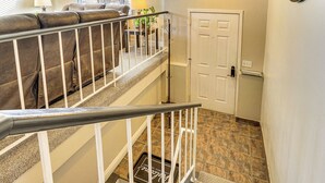 A staircase with a white railing leading to a second floor. A white door is visible on the right side. - Stunning SLC Basecamp: Ski, Explore & Unwind (Salt Lake City)