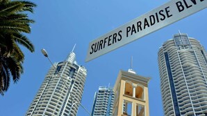 A street sign reading "Surfers Paradise Blvd" with modern high-rise buildings in the background. - Circle on Cavill - Ocean-View Apartment (Surfers Paradise)
