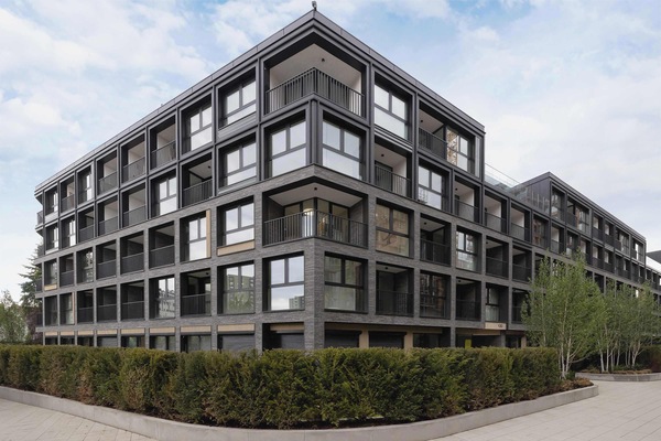 Contemporary residential building with balconies and clean architectural lines.