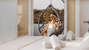 A room with a bed, a hanging chair, and a view of the outdoors. - Naxos Aethereal view (Naxos)