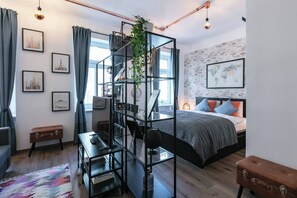 A modern bedroom with a bed, a desk, a bookshelf, and a window. - 6 min walk to metro - 3 stops to city center (Wien)