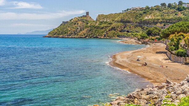 A coastal beach with clear blue waters, rocky shoreline, and a hill with buildings. - Stunning home in Altavilla Milicia (Altavilla Milicia)