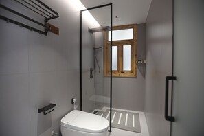 A modern bathroom with a glass-enclosed shower, a toilet, and a window. - Zhangjiajie Zhiguiju (Zhangjiajie)