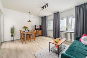 Comfort Apartment, Courtyard View | Living room | 40-inch flat-screen TV with digital channels - Lumina cozy 3-room apart near the metro (Warsaw)