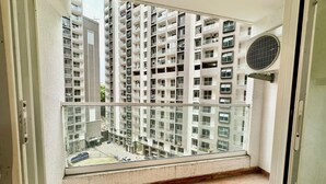 A balcony with a view of high-rise residential buildings. - Luxury 1401 Pixiestays With Free Parking (Mumbai)