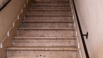 Un escalier doté d’une rampe et d’un mur orné d’un motif en relief.