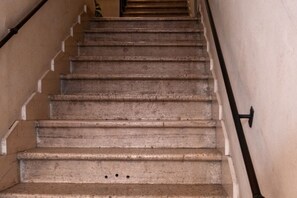 Un escalier doté d’une rampe et d’un mur orné d’un motif en relief.