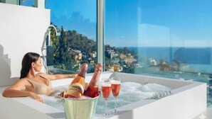 A person relaxing in a bathtub with champagne and glasses, overlooking a scenic view. - Villa in Sitges |Pool|Jacuzzi|BBQ|Views|AC|12P (Sitges)