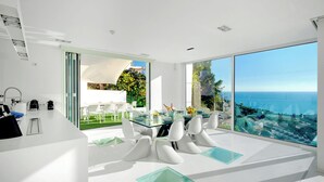 A modern kitchen with white cabinetry, a built-in oven, and a stainless steel range hood. - Villa in Sitges |Pool|Jacuzzi|BBQ|Views|AC|12P (Sitges)