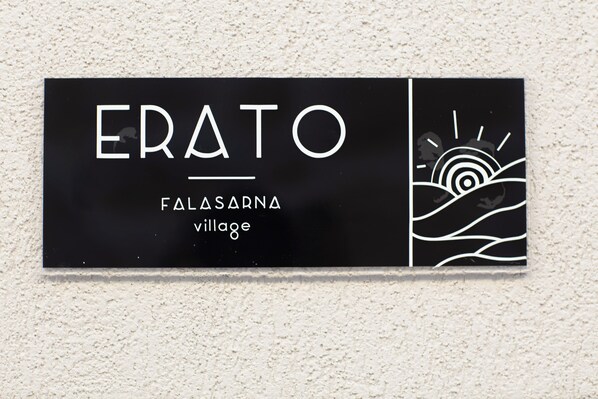 A black sign with white text reading "ERATO" and "FALASARNA village". - Falasarna Village (Kissamos)